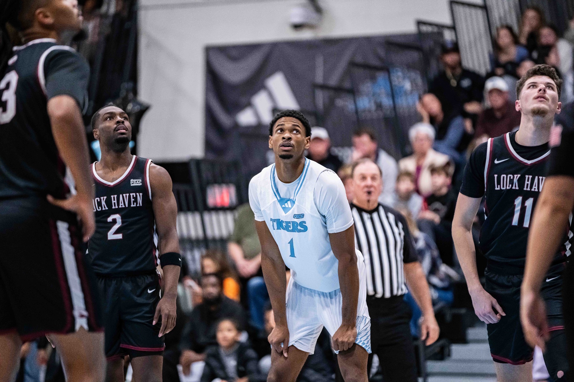 A closeup of Najee Coursey with his hands on hit knees as a teammate shoots a free throw