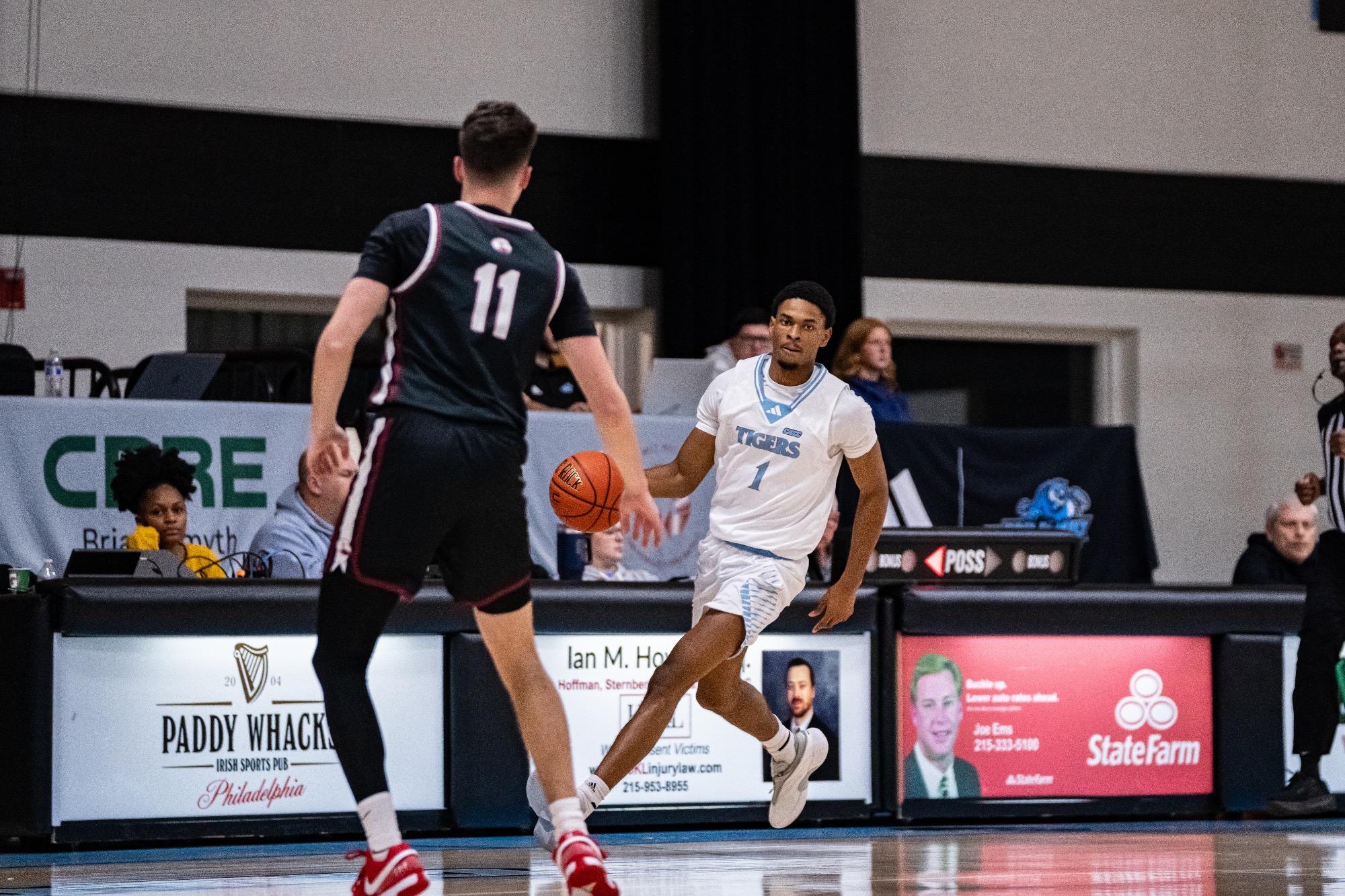 Najee Coursey dribbling with his right hand, an opponent in front of him