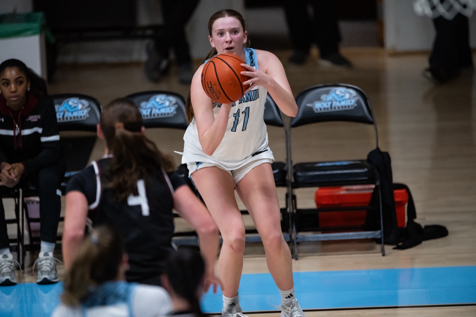 Kara Meredith about to shoot, her knees slightly bent with the ball still in her hands