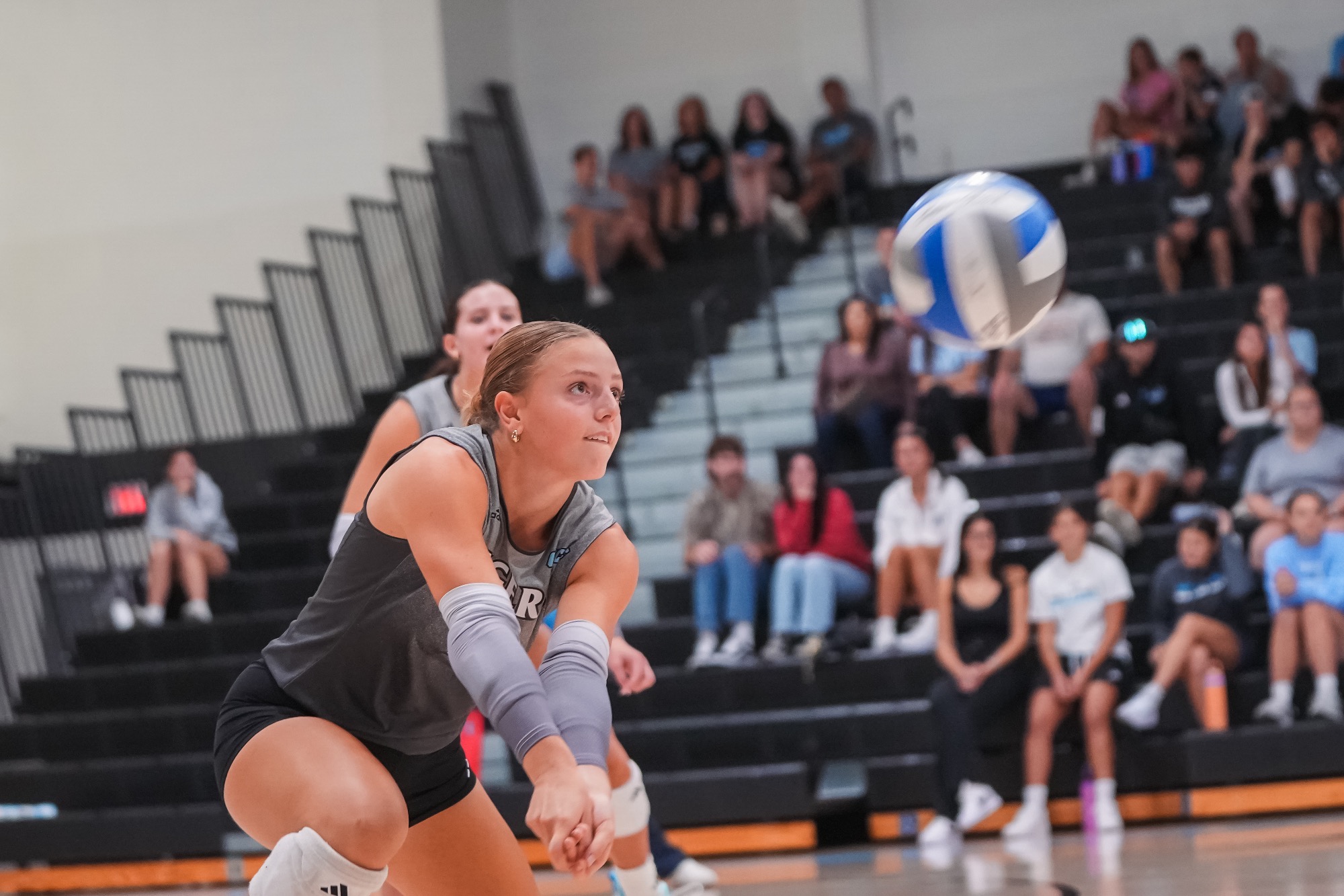 Cadence Palmer about to dig a volleyball