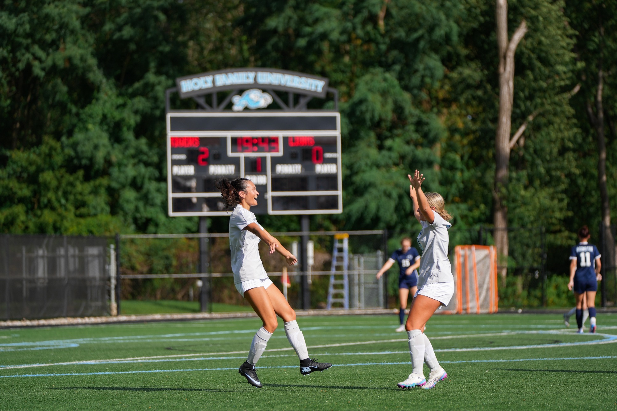 Kayla Balisalisa and Kenna Rozanski about to hug each other following a goal
