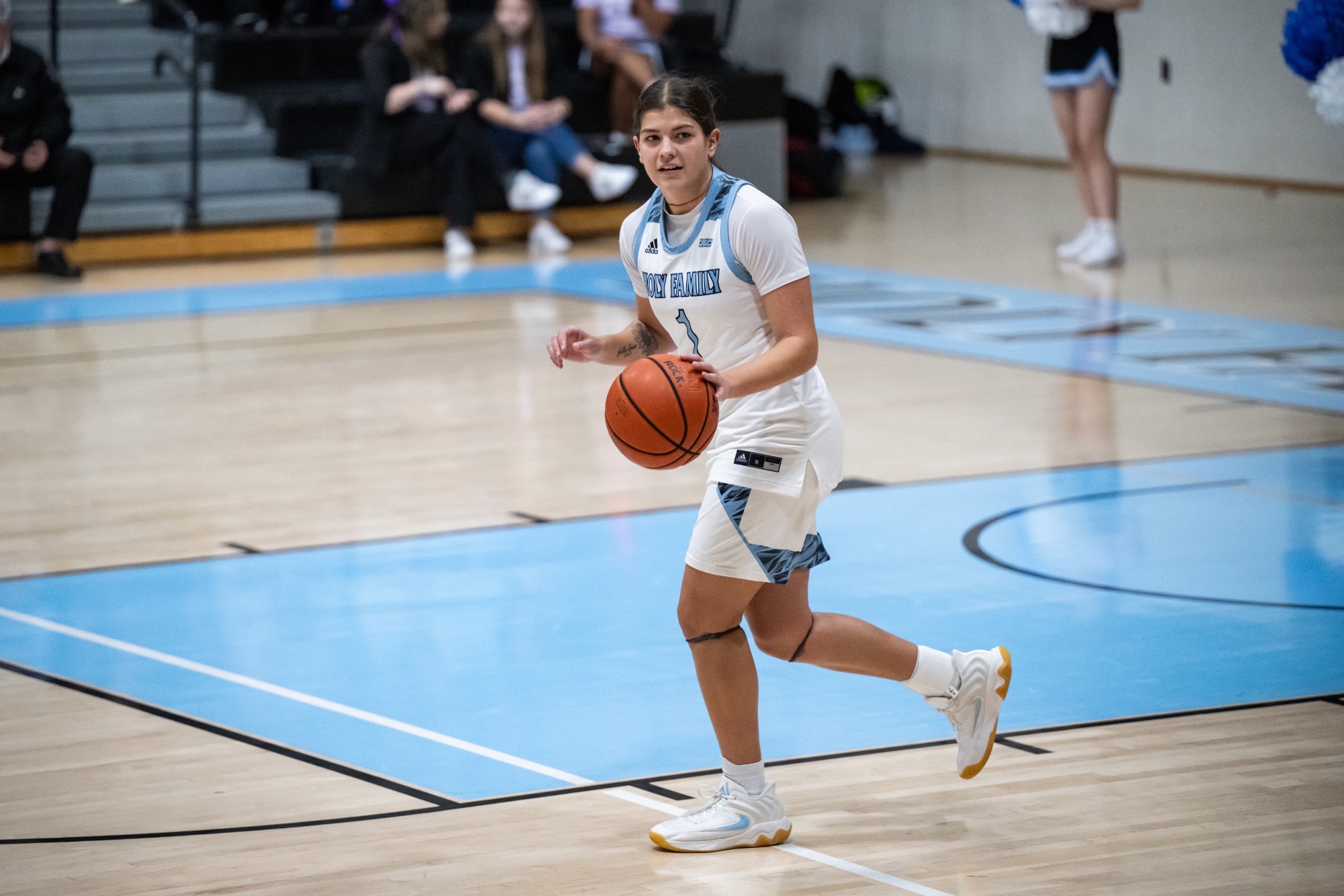 Lola Ibarrondo dribbling the ball with her left hand, looking toward her right
