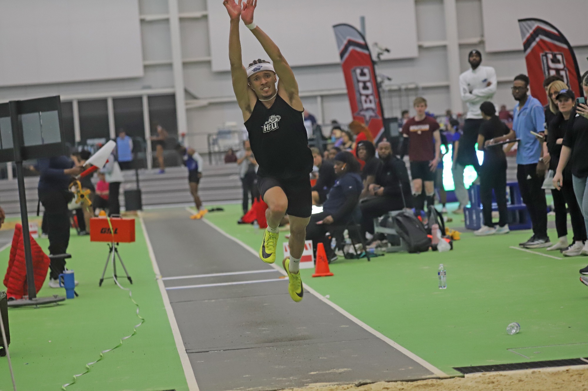 Ernest Robertson in the air after jumping in the triple jump