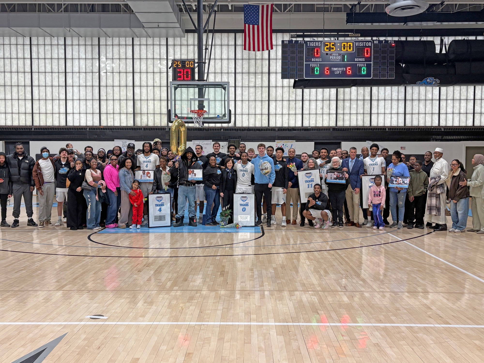 The HFU Men's Basketball Class of 2026 gathers with family, friends, coaches and teammates for a group picture on Senior Day