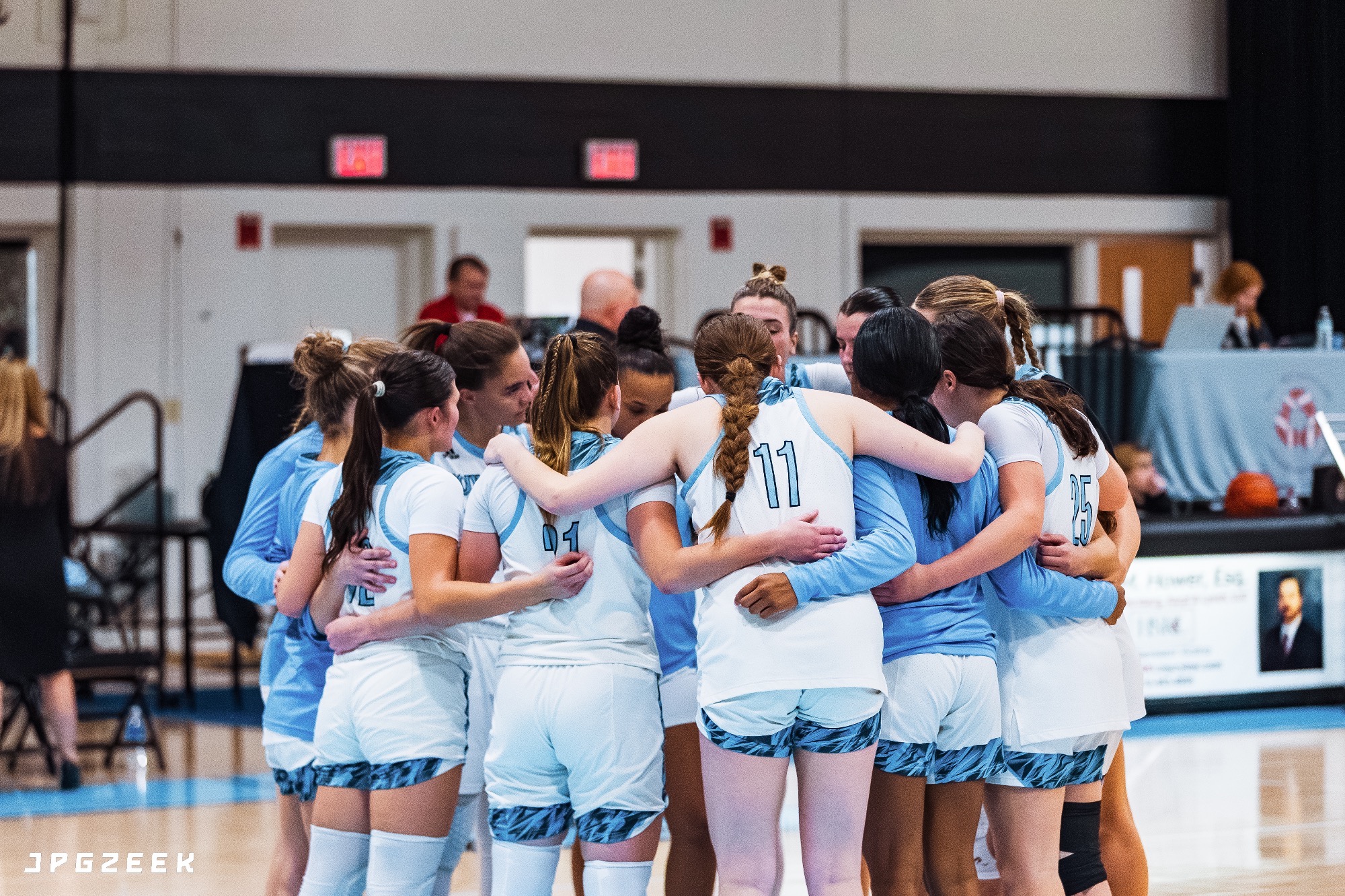 The HFU Women's Basketball Team gathers for a team huddle on the court