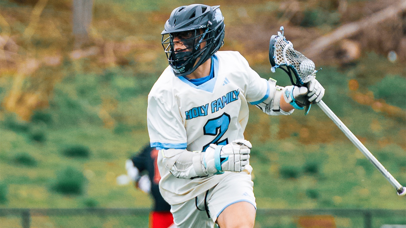 A closeup of Maxx Covely, cradling with his stick in his left hand