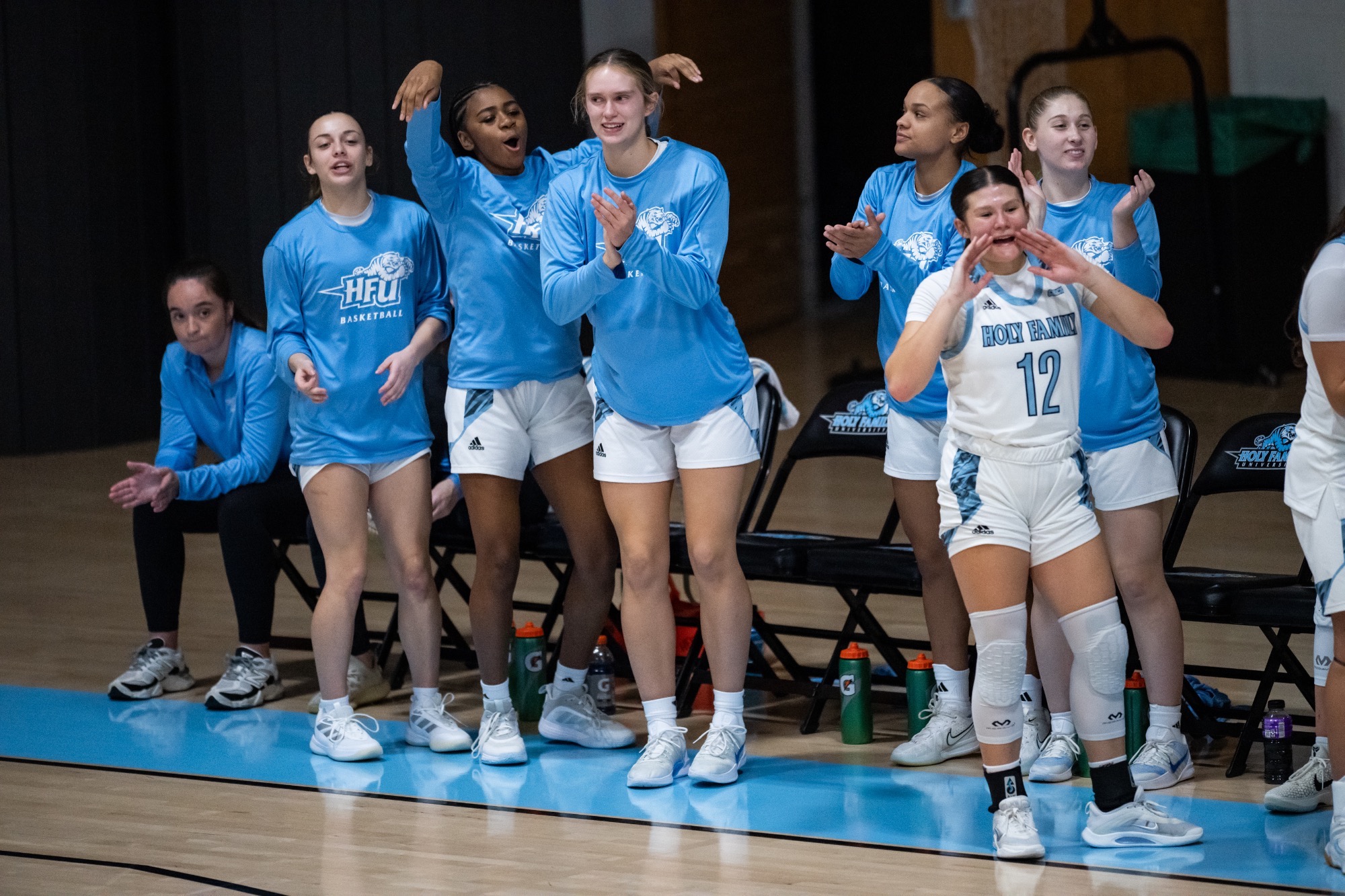 Members of the HFU Women's Basketball bench celebrate