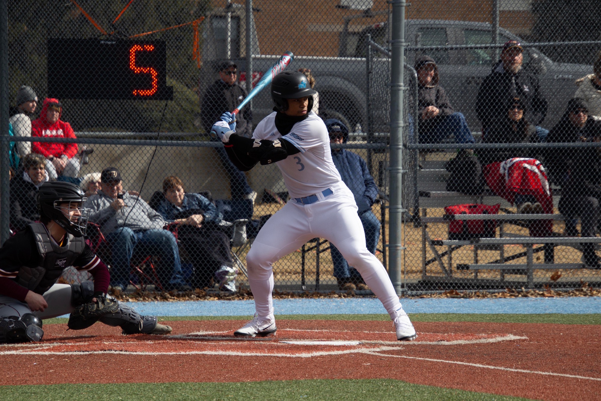 Andres Rivera begins his swing from the right-handed batter's box