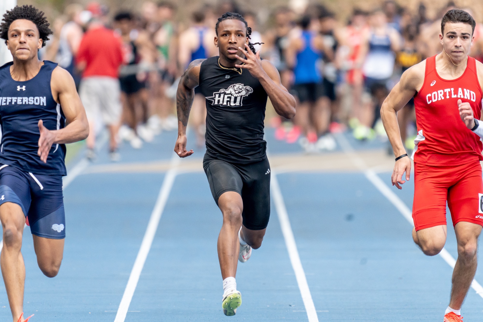 Theo Sample running in-between two competitors