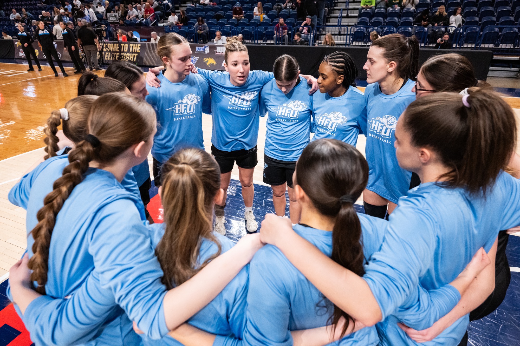 The 2025-26 HFU Women's Basketball Team huddles prior to its Elite Eight game