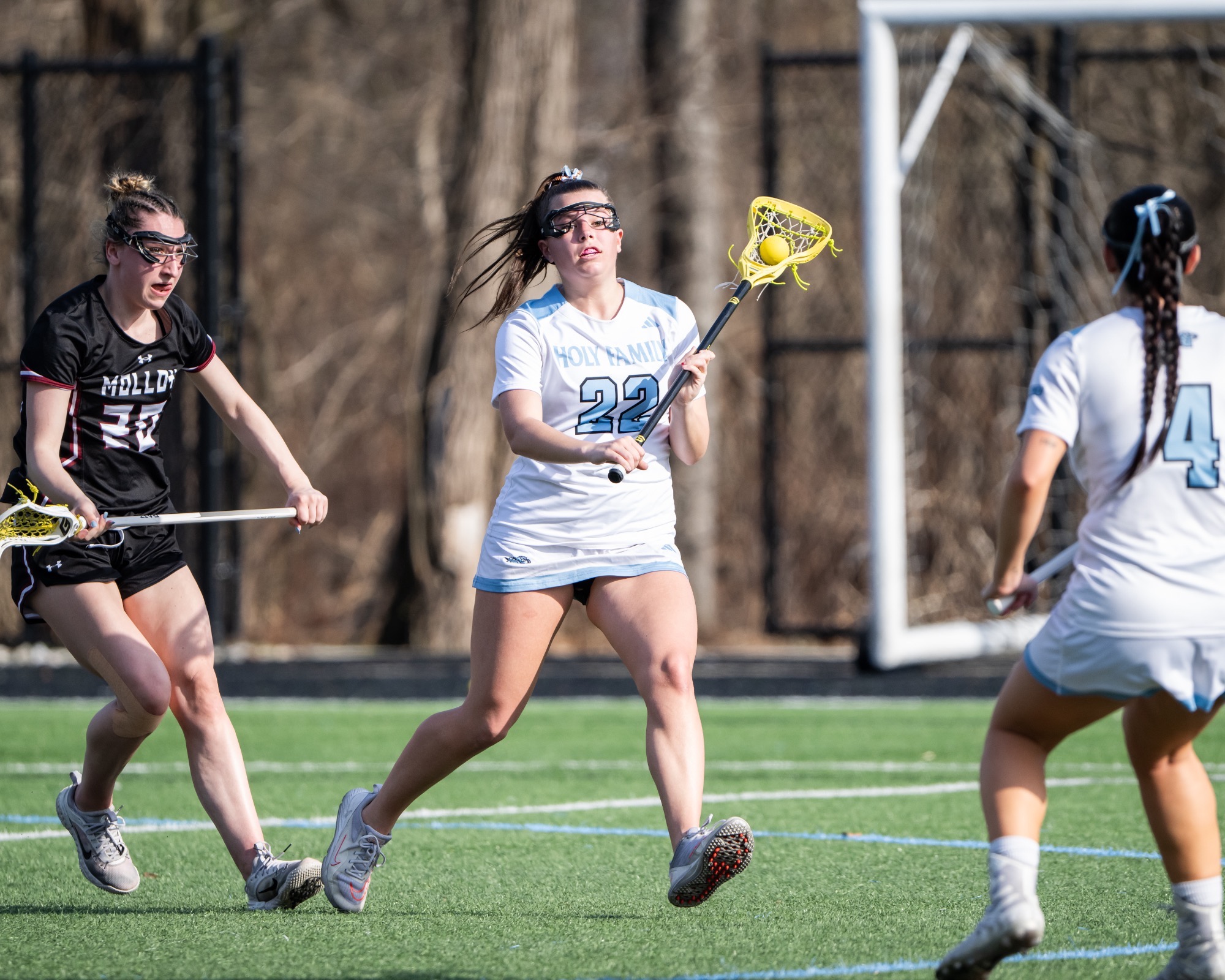 Morgan Wise possesses the ball in her stick, which is in her left hand