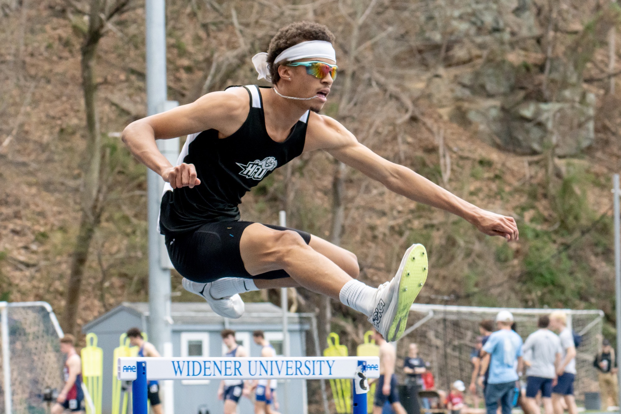 Ernest Robertson jumping over a hurdle