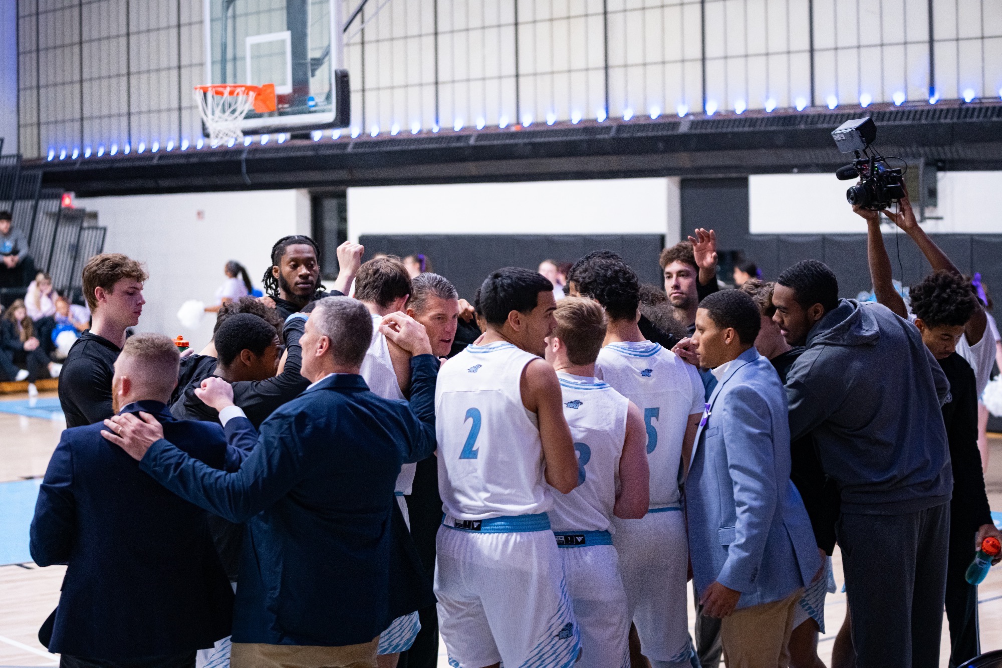 The 2025-26 HFU Men's Basketball breaking from a huddle following a timeout