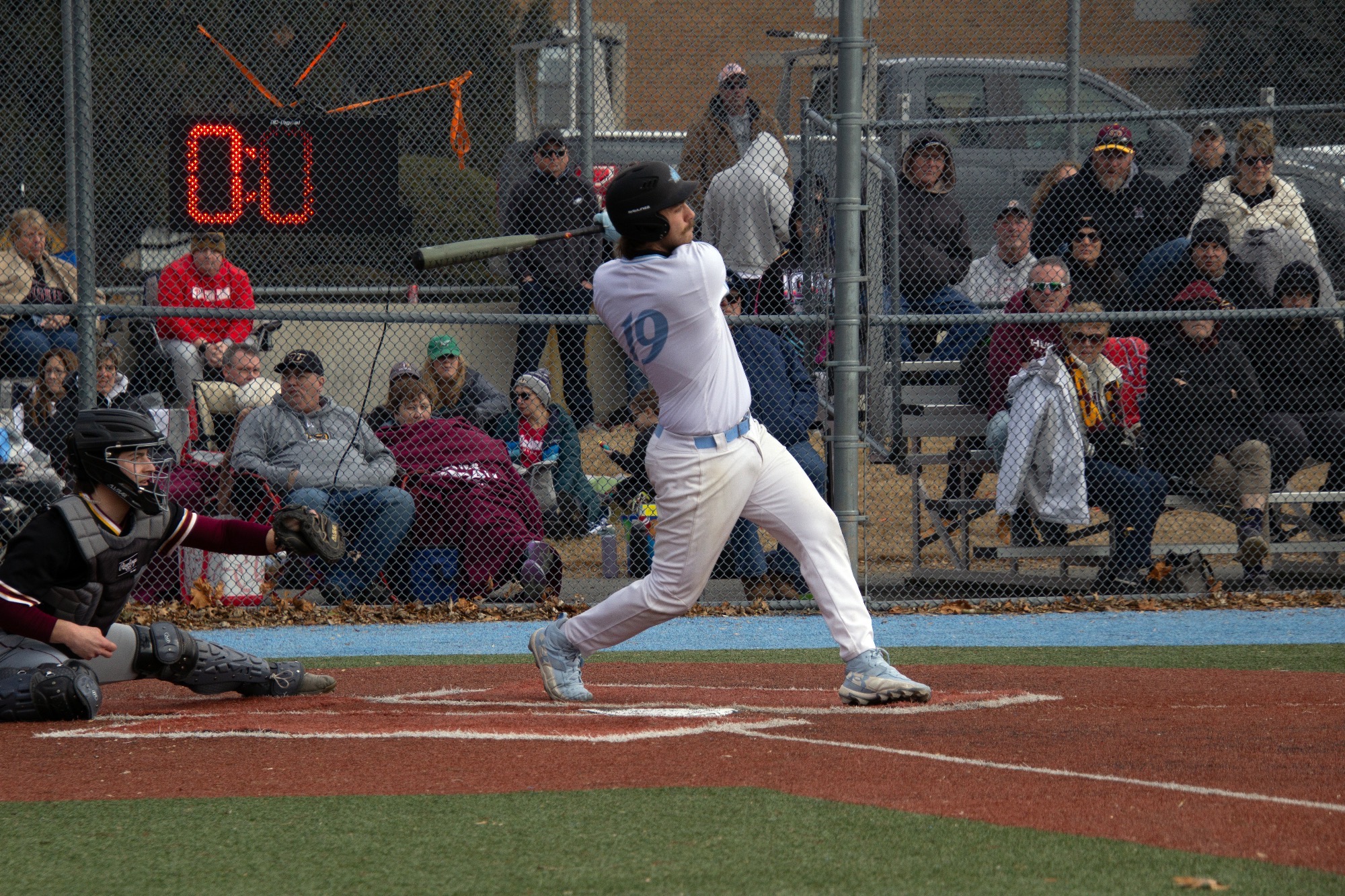 Peter Hrousis having just completed his swing from the right-handed batter's box