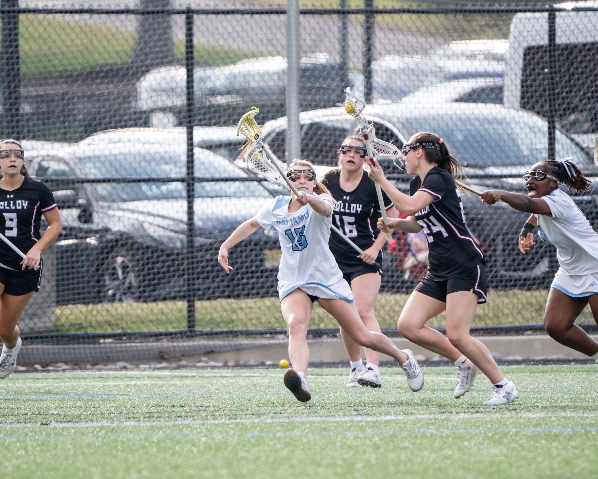 Casey Schuette holds her stick up in front of an opponent