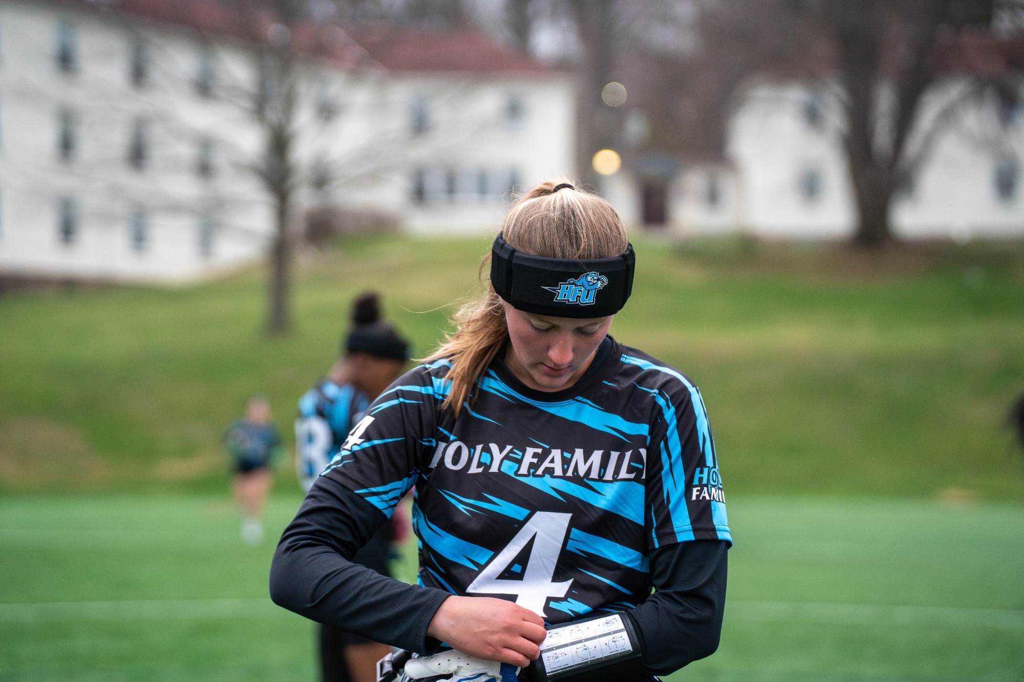 Morgan Simms looking down at her wristband, adjusting her glove