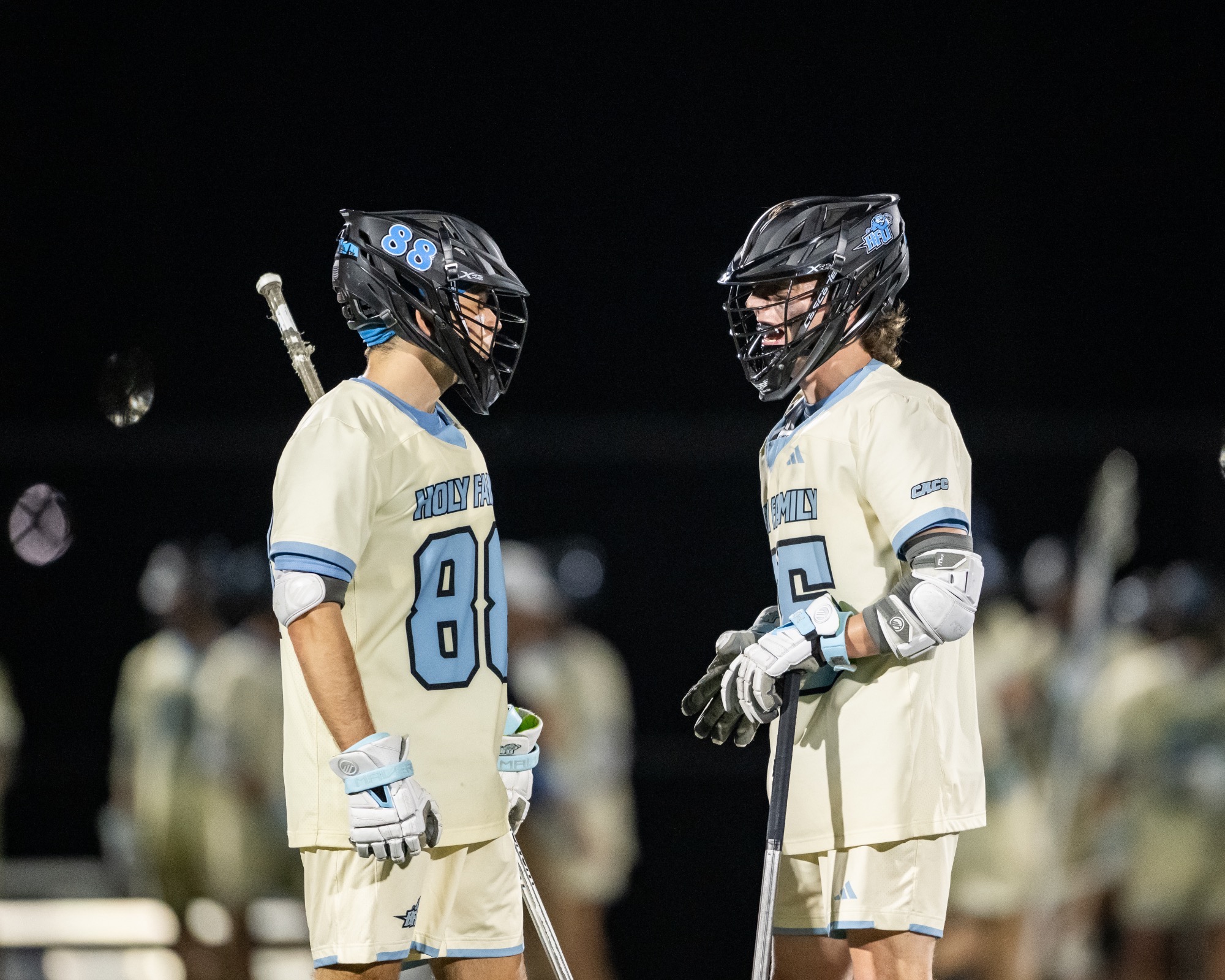 A closeup of Jackson Brown and Frank Britsch talking on the field