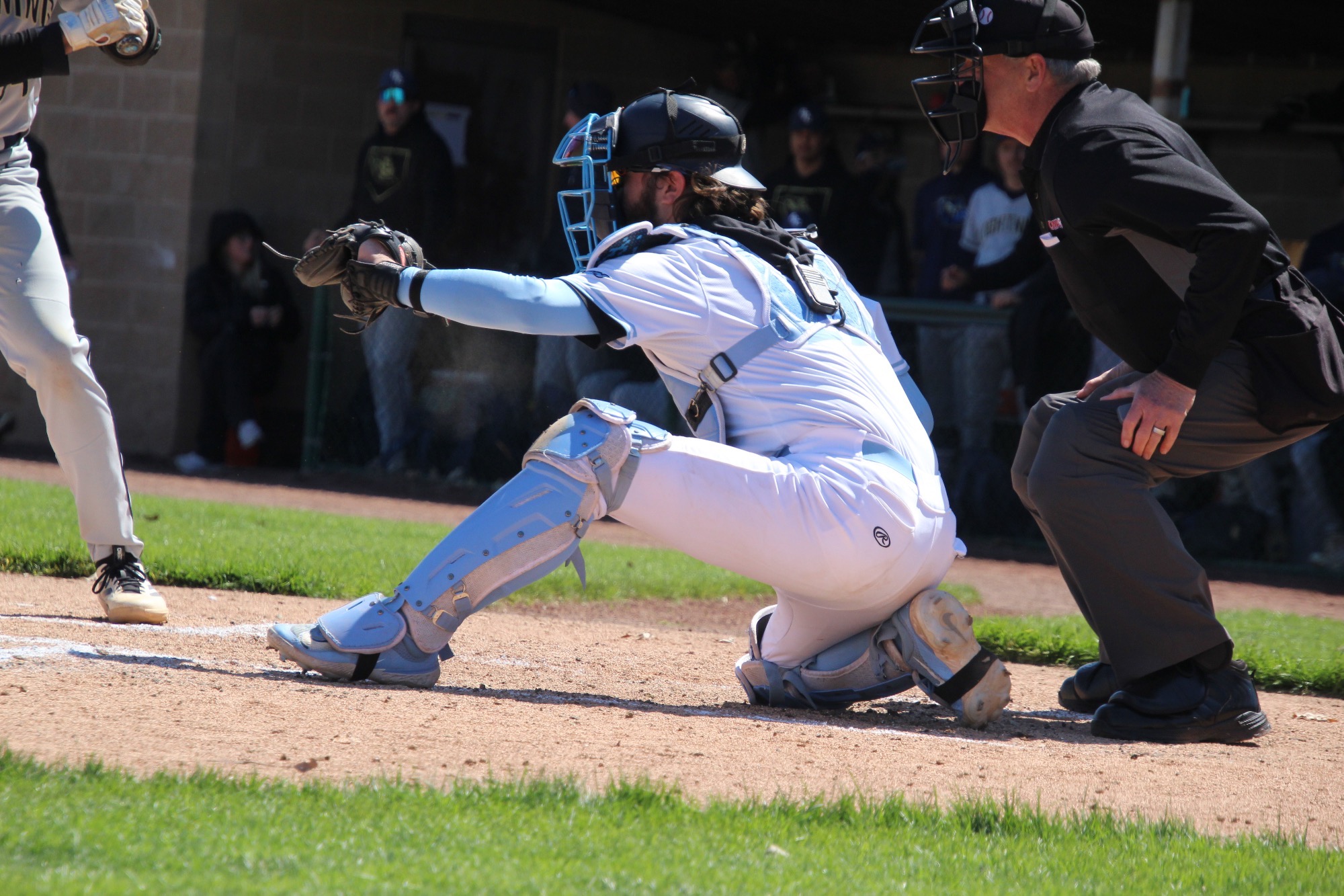 Catcher Perry Chetney, from the left, about to catch a pitch behind home plate