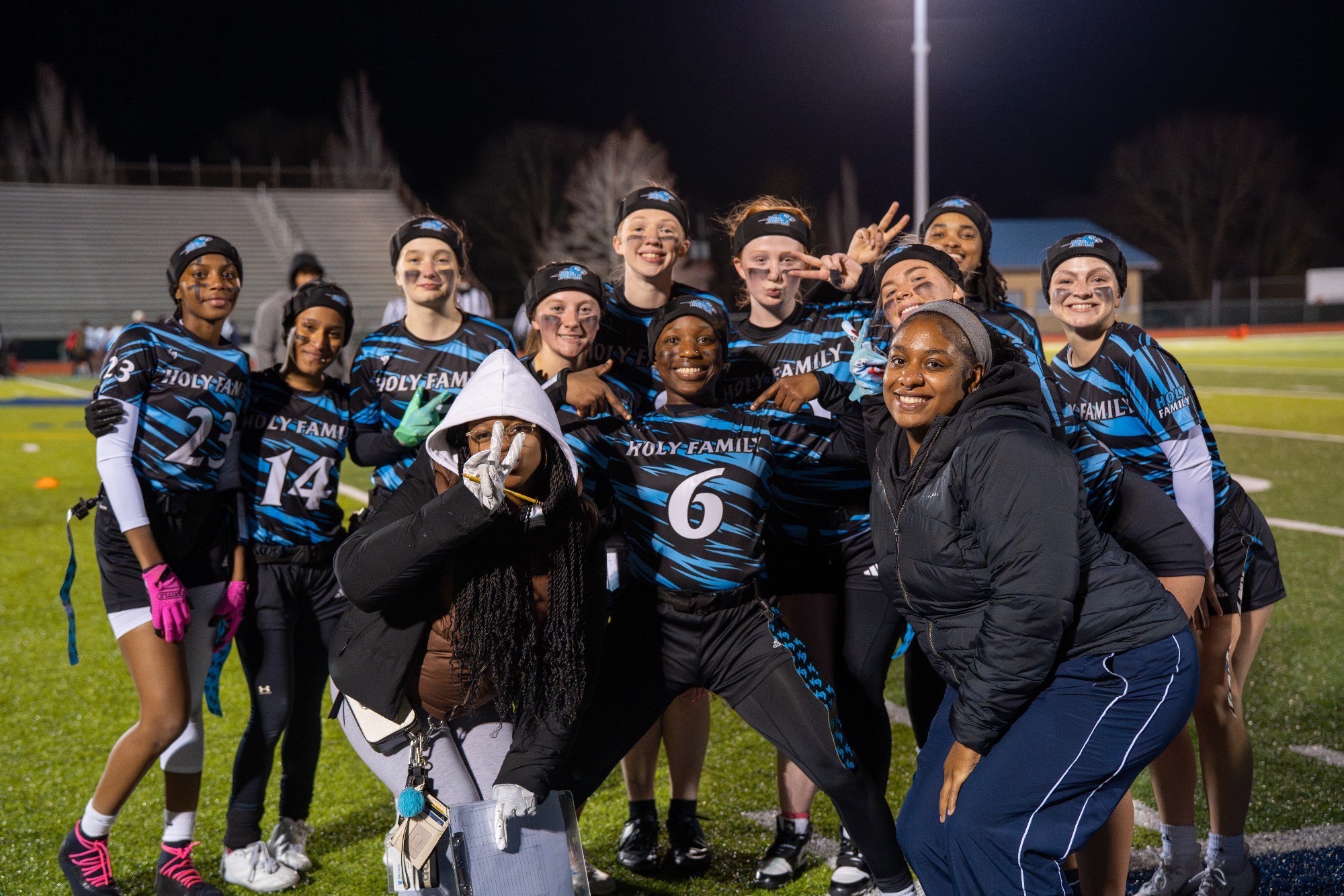 The 2026 HFU Flag Football Team takes a group pictures, celebrating after a win