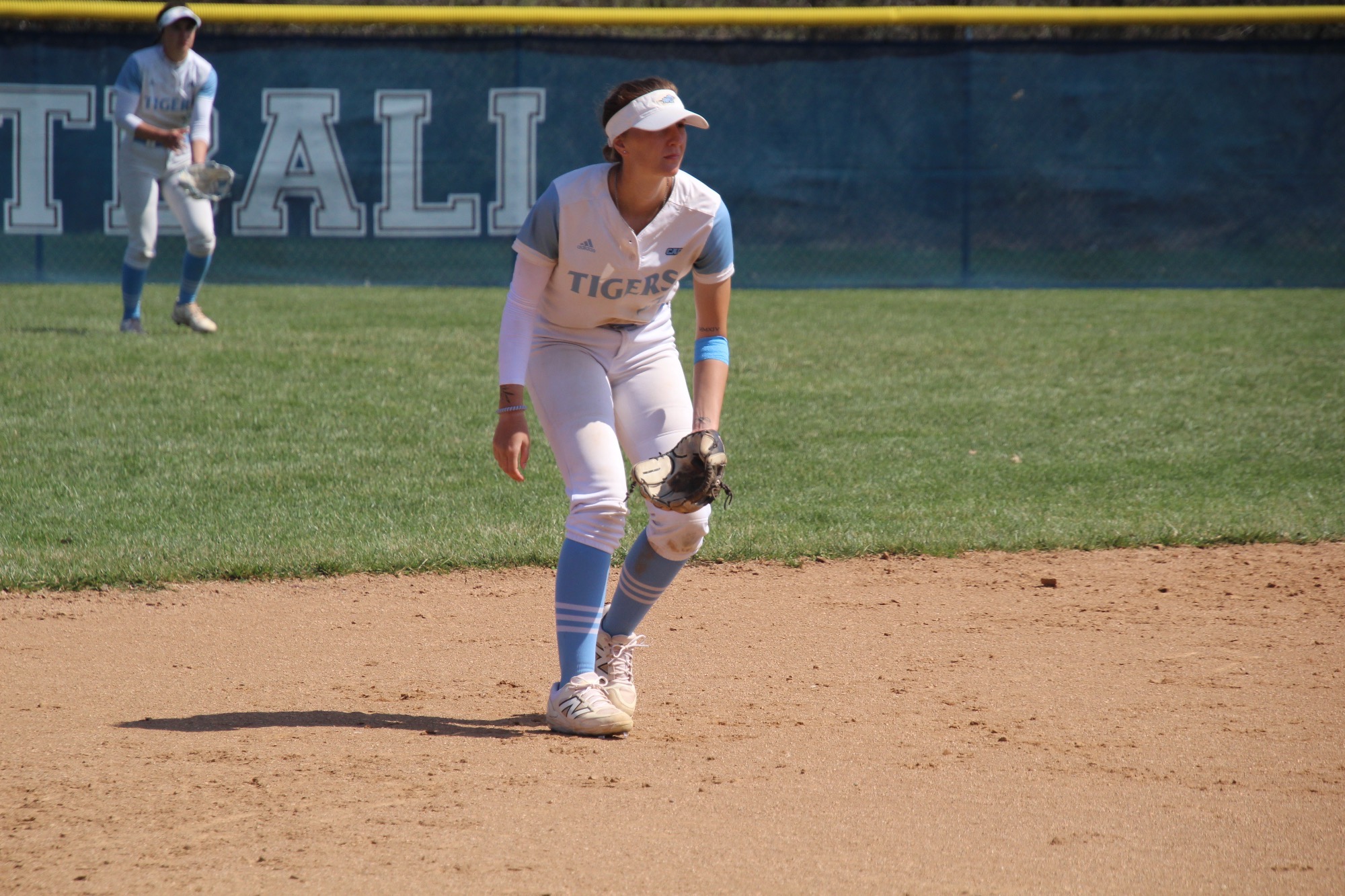 Shortstop Kylee Jones enters a ready position as a pitch is being thrown 