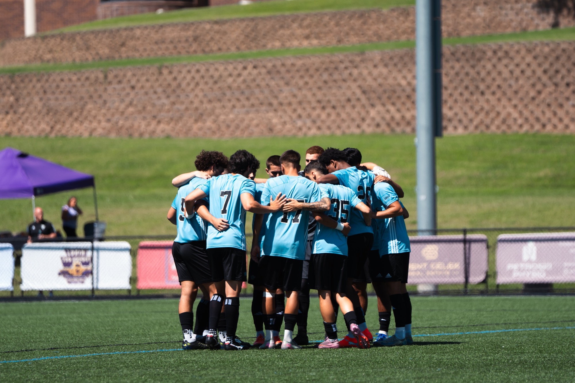 The HFU Men's Soccer Team huddles on the field prior to its match against West Chester