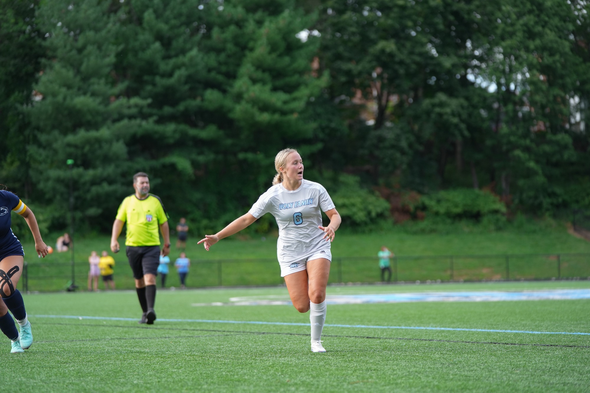 Kenna Rozanski calling for a pass, running with her right arm out 