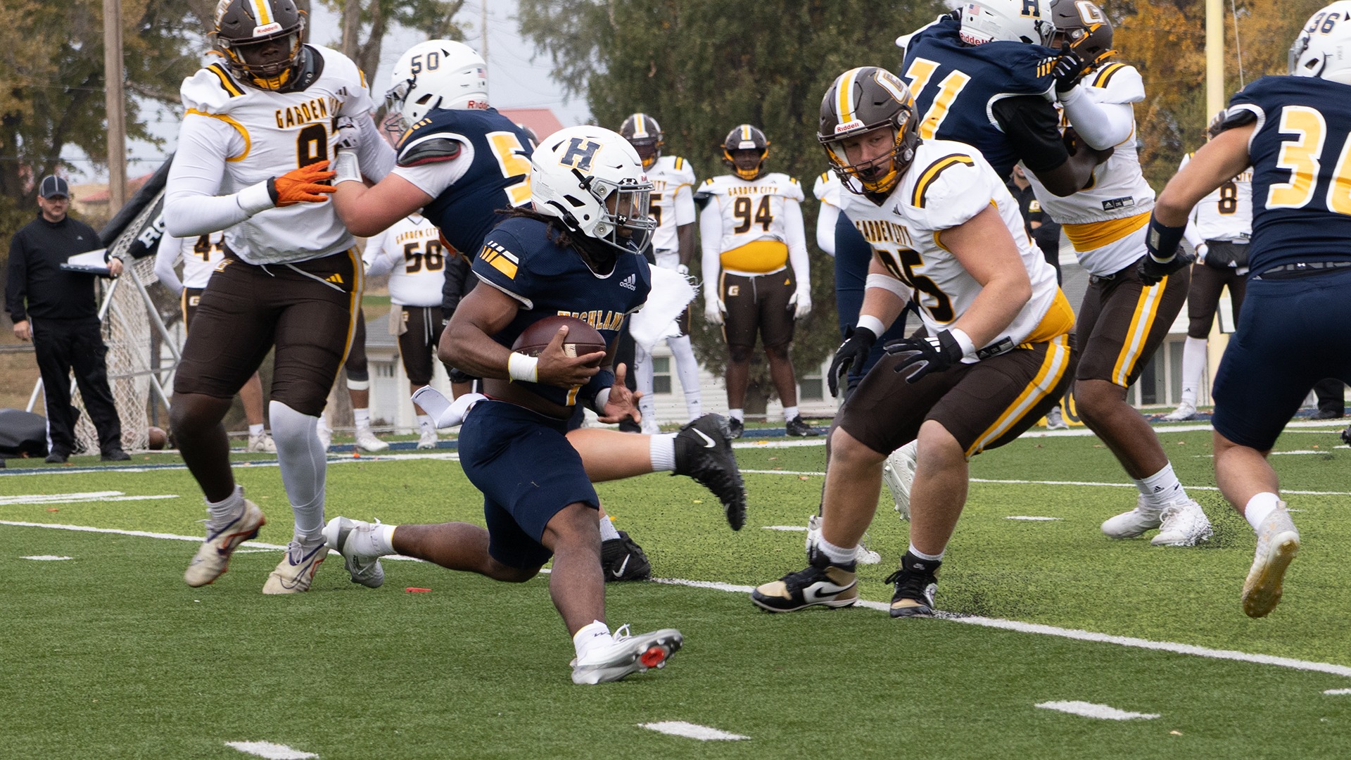 TJ Porter (1) carries the ball upfield into a crowd of Garden City defenders