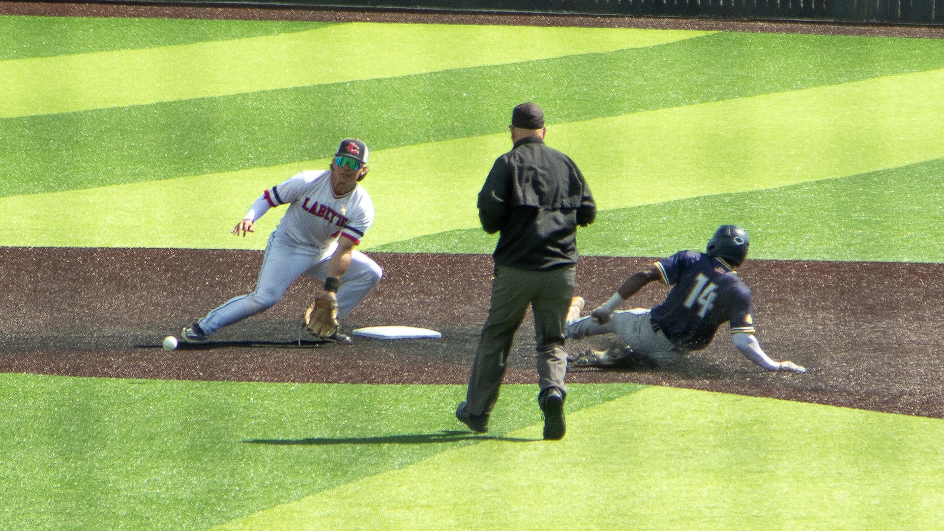 Isaiah White slides into second ahead of the tag against Labette County, tying Highland's single-season stolen base record (33)