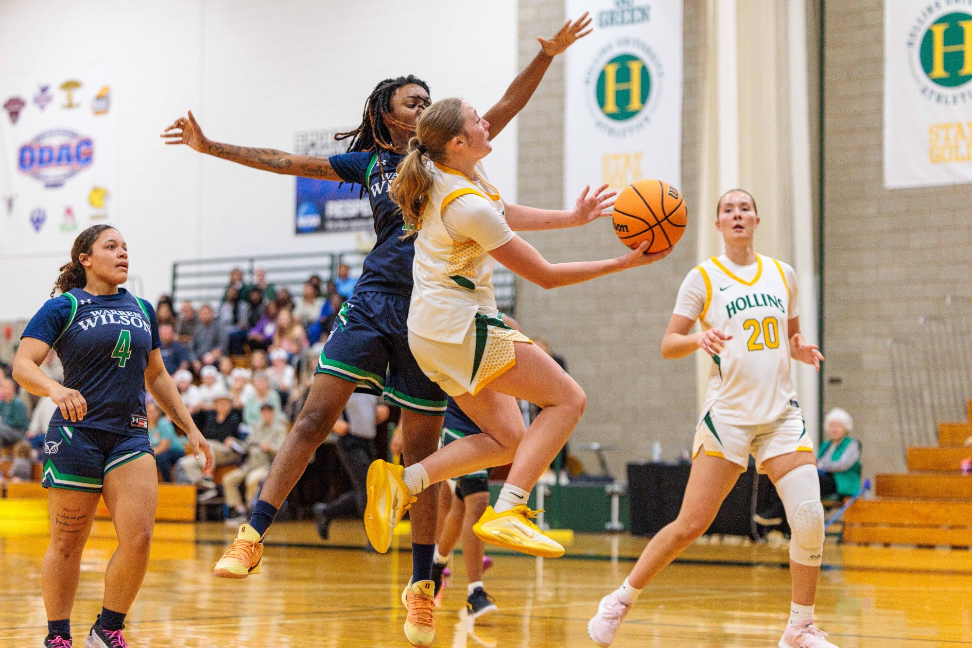 Abby Kingery driving against a defender for the shot
