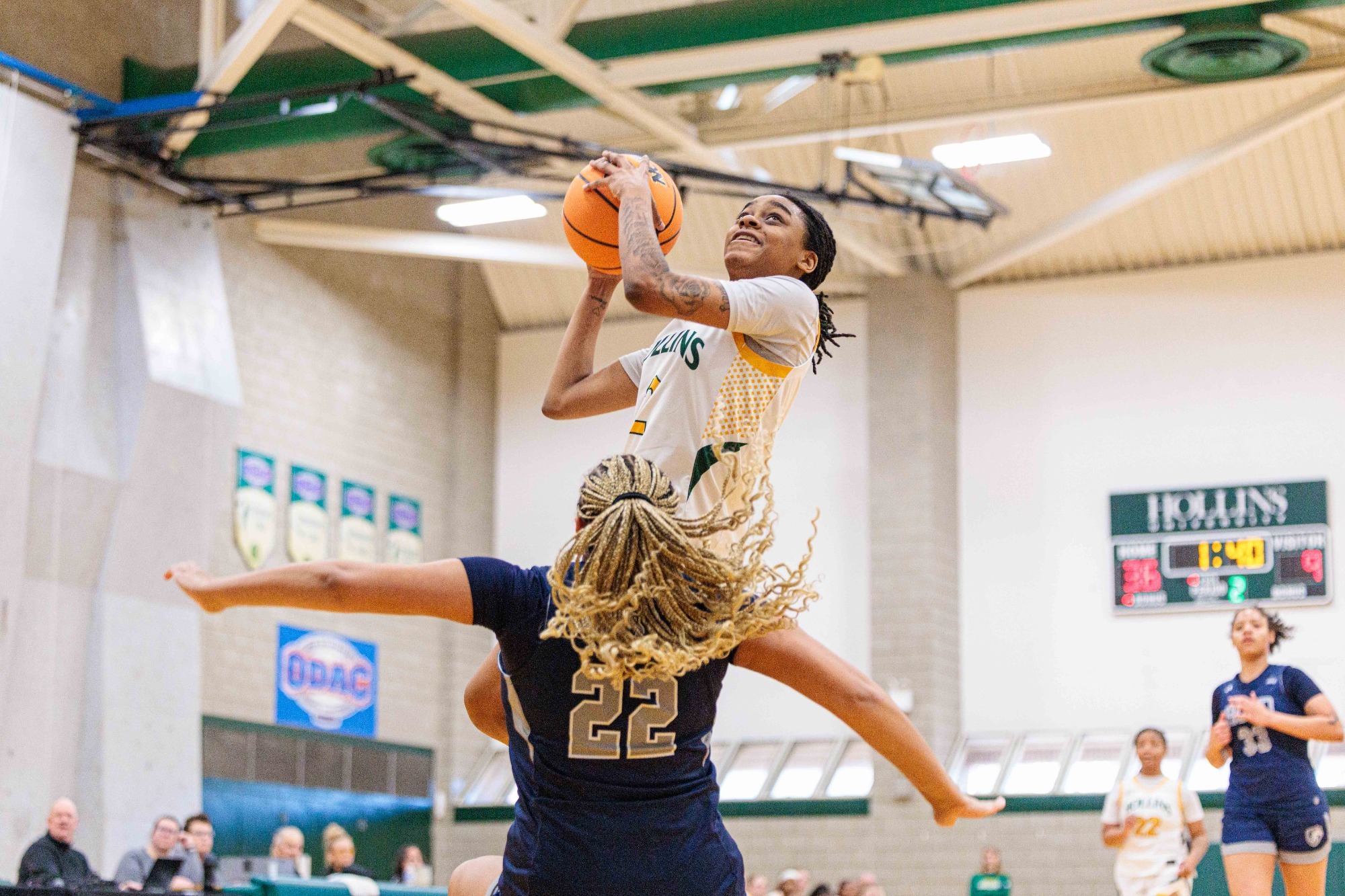 Jacorra Russell with a fast break hoop over a defender