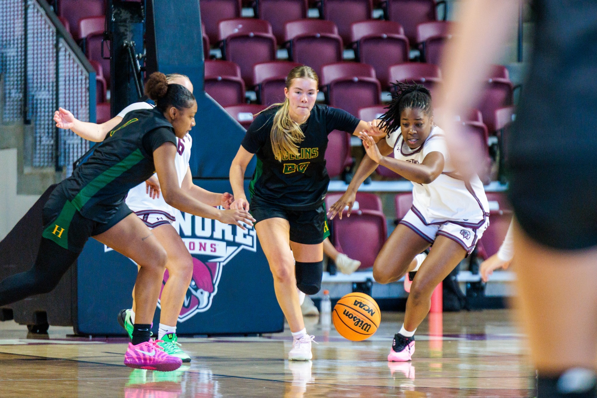 Gracie Huffard on defense as she and Zaria Holden go after a loose ball