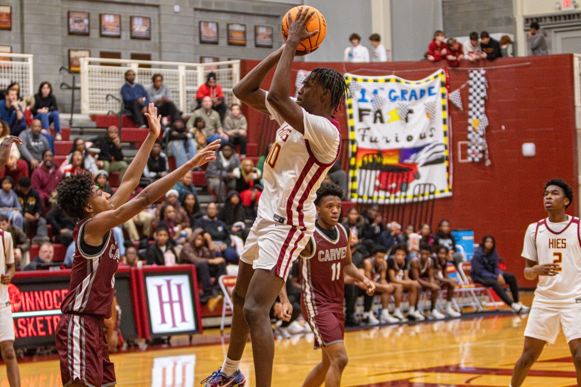 HIES boys basketball players compete against Carver during Winterfest 2026.