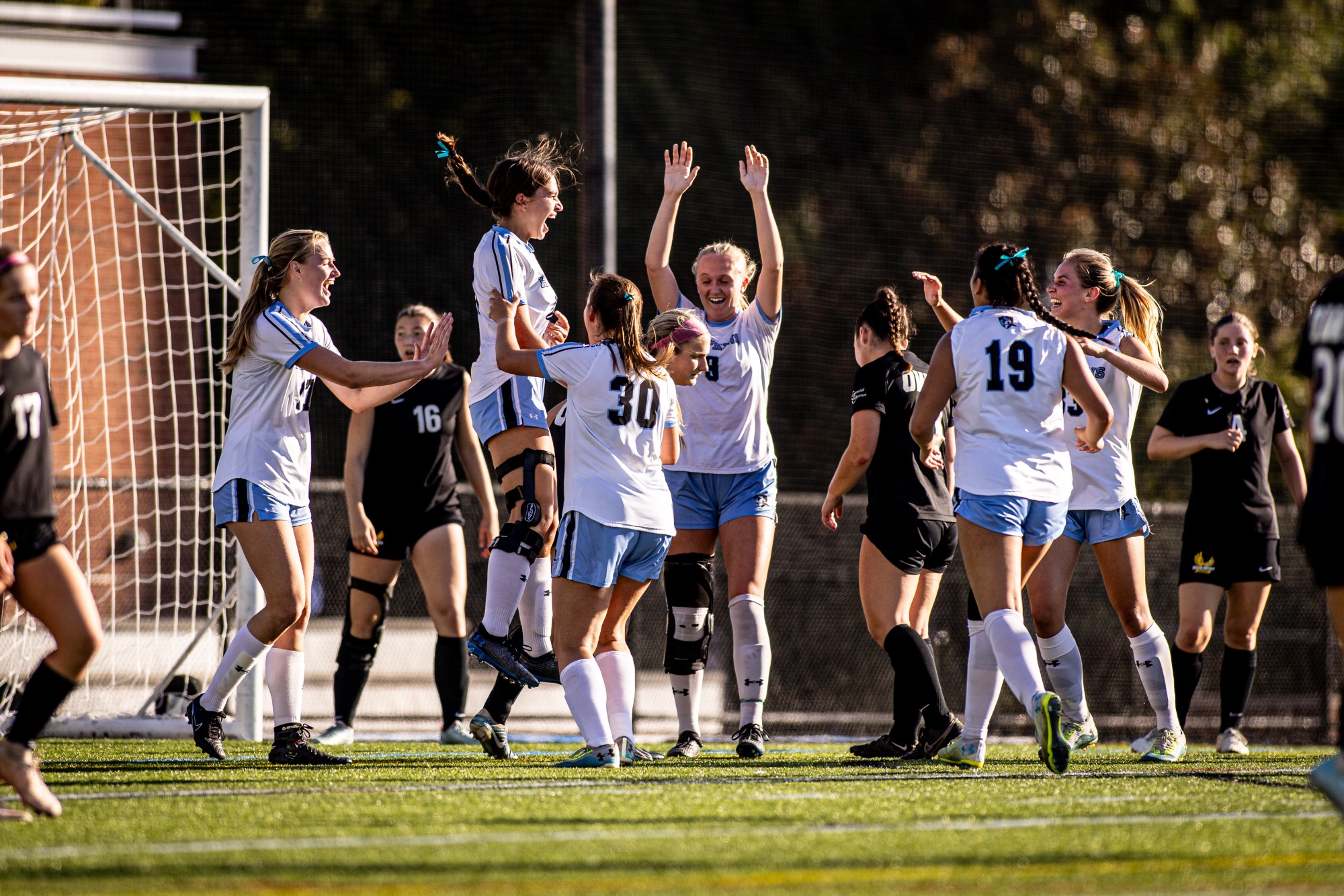 First career game ... first career goalie for Blue Jay freshman Maddie Burchfiel (jumping).