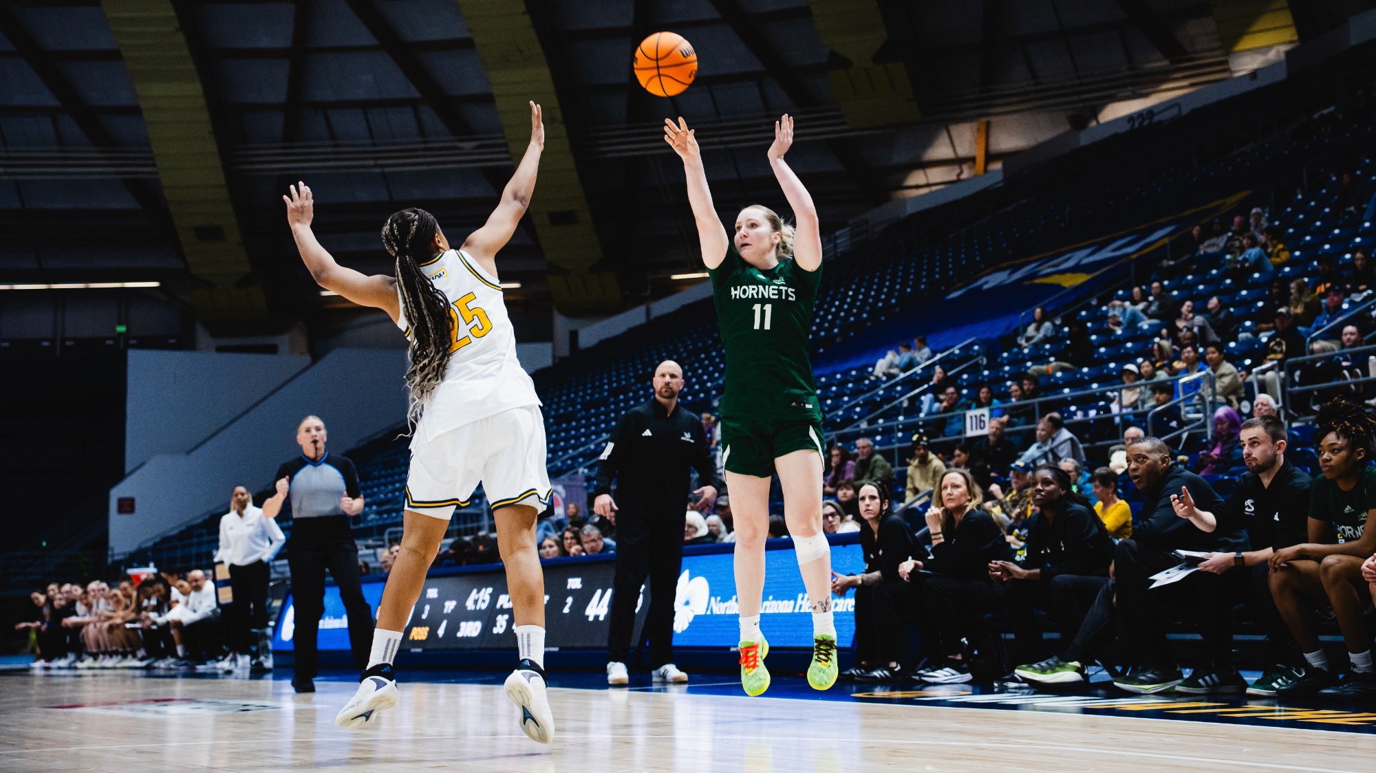 2025-26 WBB Rubi Gray attempts a three-pointer in front of the Sacramento State bench in a win at Northern Arizona