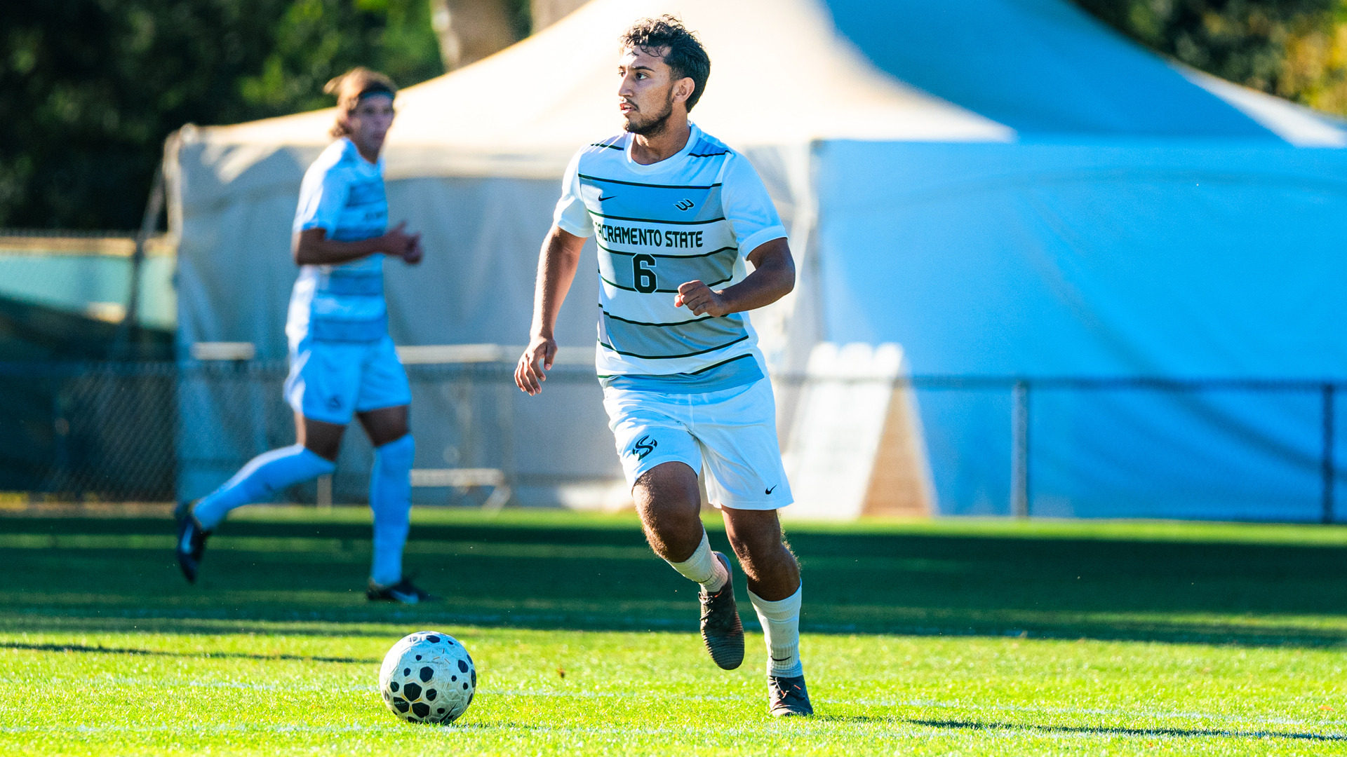 2026 MSOC Gio Ceja looks up the field with the ball in a home match against UC San Diego