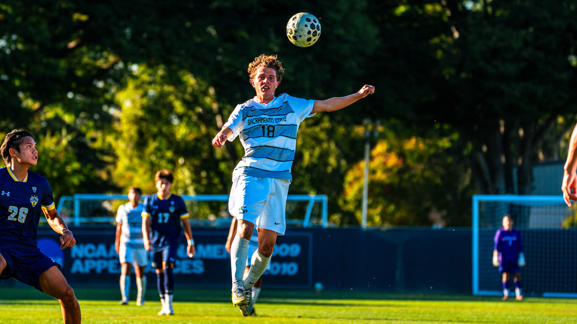 2026 MSOC Zach Looney heads a ball in the midfield in a home match against UC San Diego