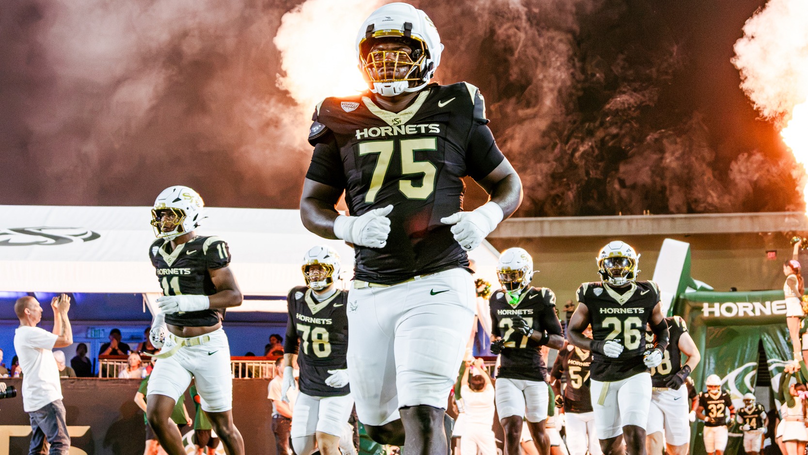 DeAnthony Sheffield runs out with the team. Pyrotechnics in the background