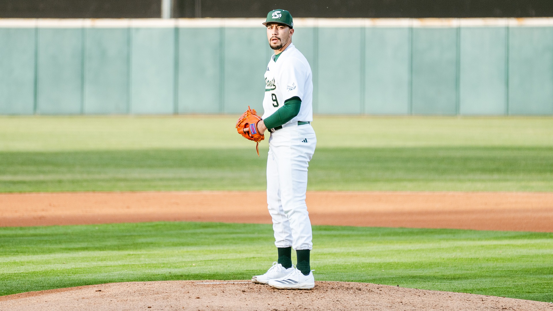 Elijah Rogalski stands on the mound looking towards the catcher