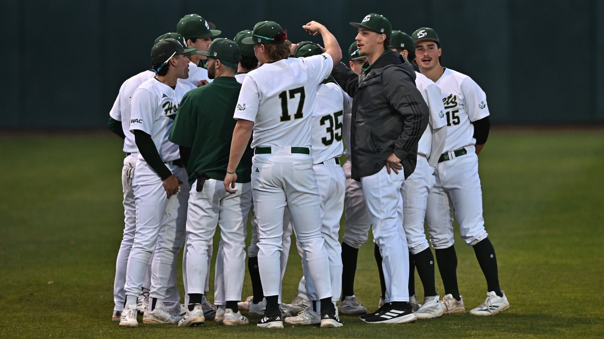 2026 BSB team huddle in the outfield prior to the second game of the series against Saint Joseph's