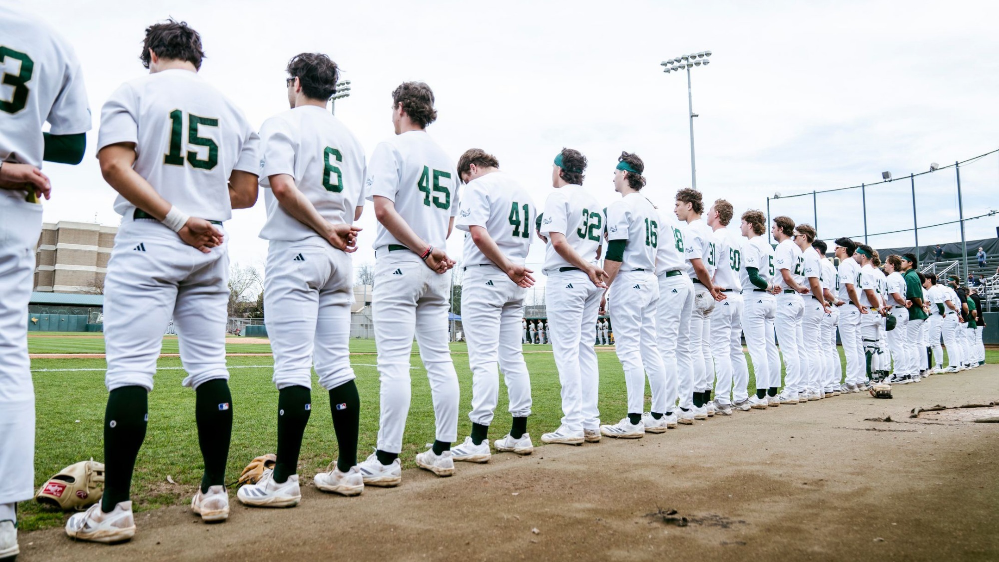 2026 BSB Sacramento State players line up in front of the dugout for the National Anthem prior to first pitch against California on Feb. 28
