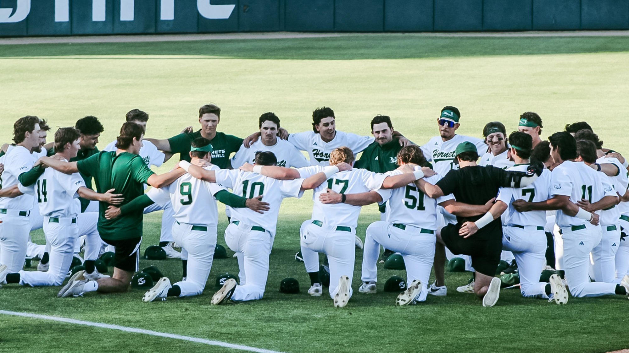 2026 BSB Team huddle in the outfield prior to first pitch against San Francisco