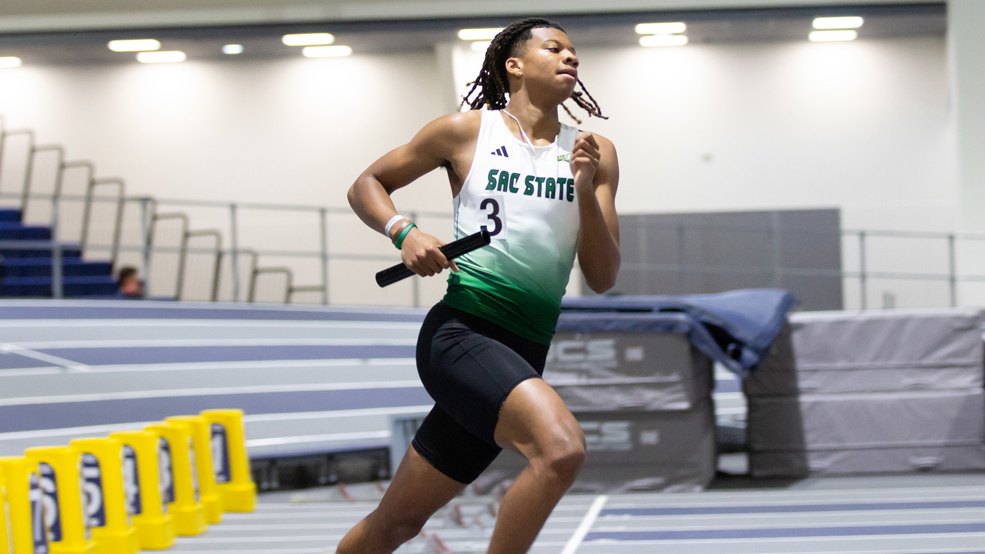 Image of Jonas Petty carrying a relay baton 