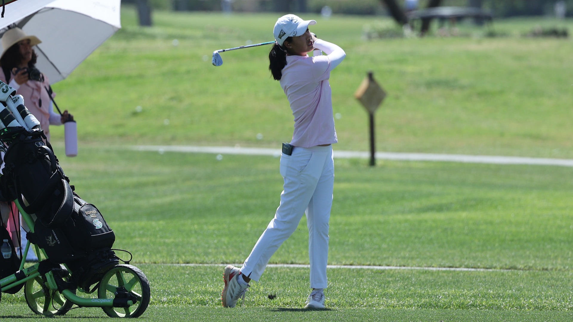 Sophia Lee follows through on an iron shot from the fairway