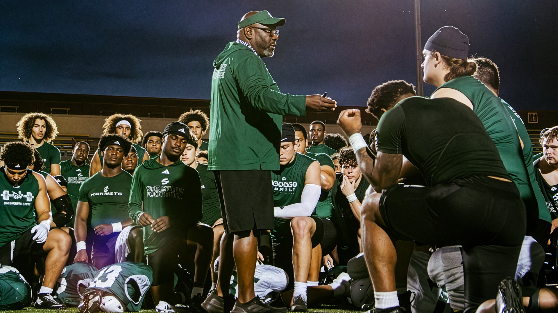 Alonzo Carter talks to the team following practice