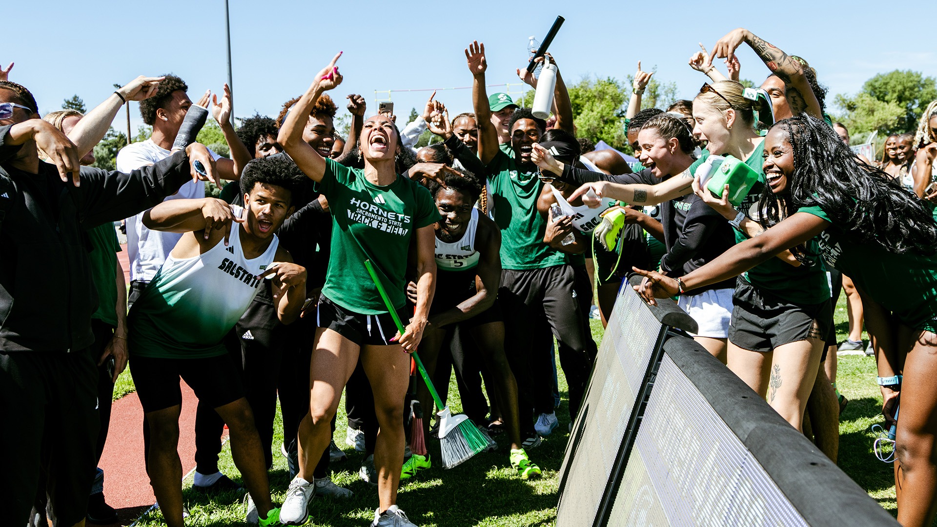 Image of several Sacramento State athletes celebrating after winning the Causeway Classic Dual