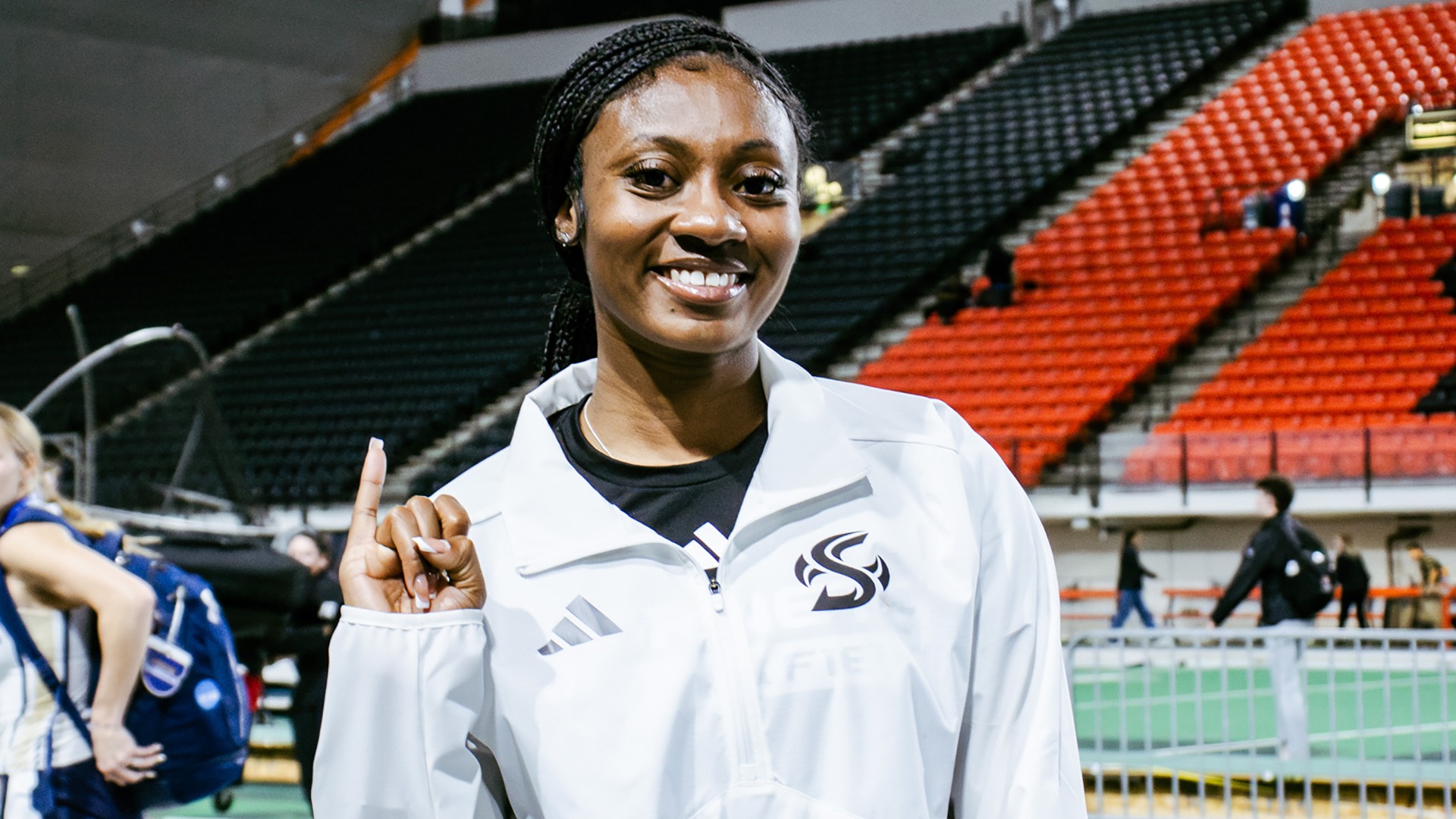 Photo of Kyra Jefferson doing the Stingers Up hand sign