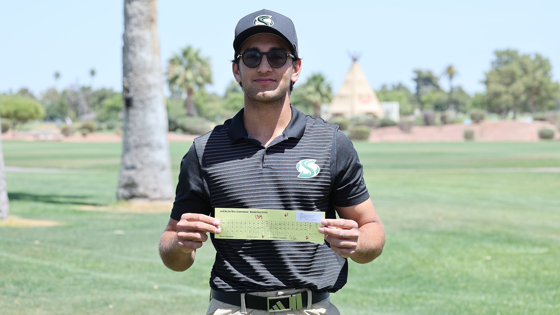 Jai Bahl holds his scorecard after shooting 61