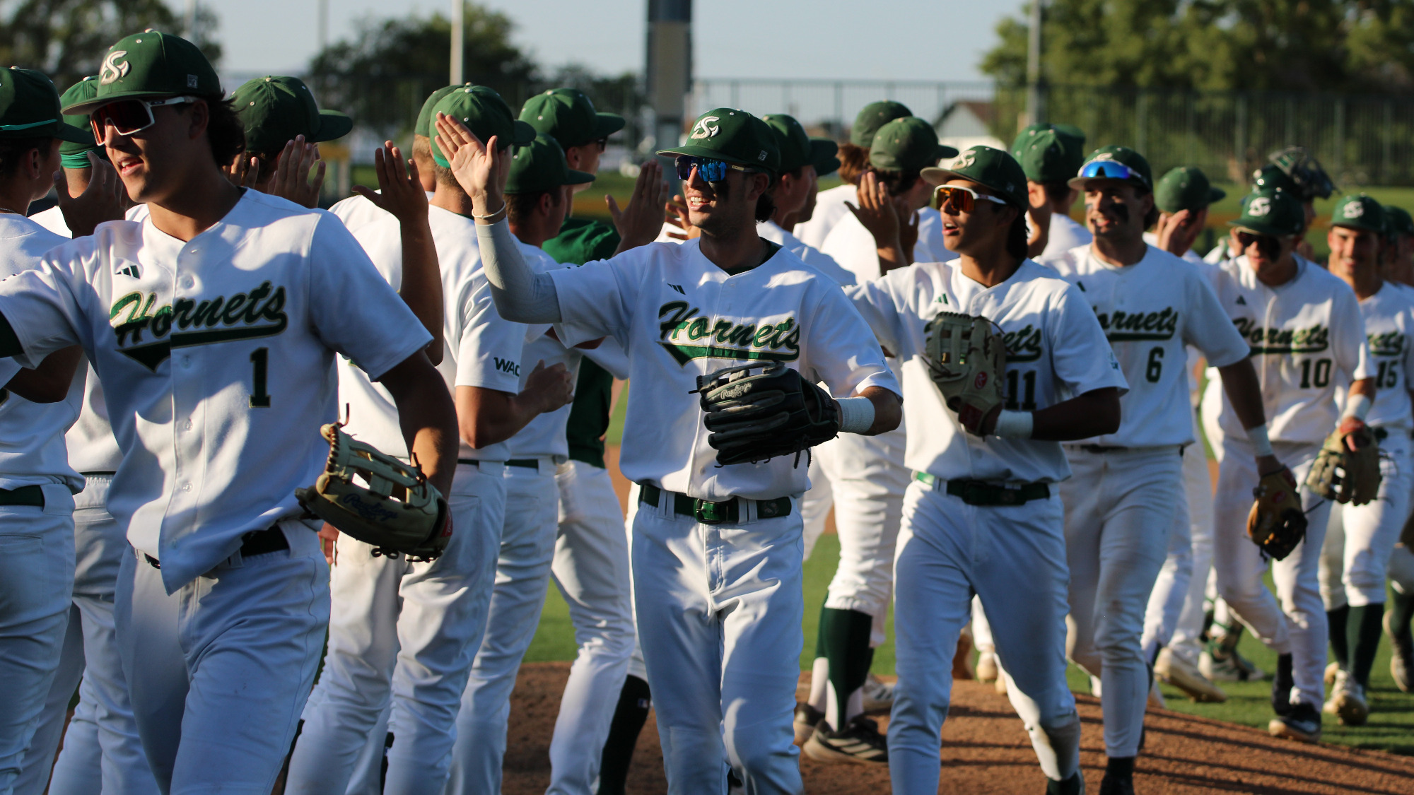 2026 BSB High fives by the Hornet players after defeating Abilene Christian in the opening round of the WAC Tournament