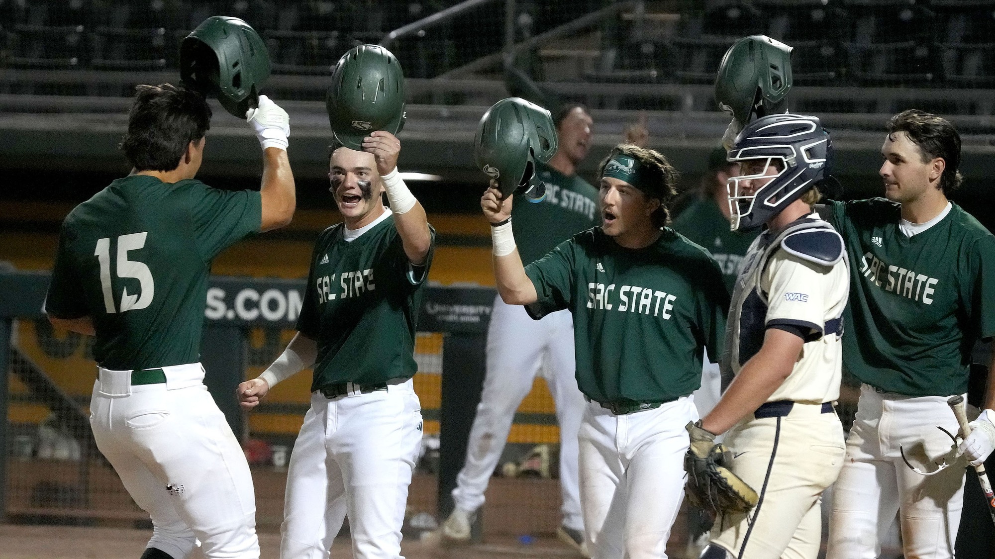 2026 BSB Jakob Poturnak touches helmets with teammates at home plate following his eighth-inning home run against California Baptist on May 22 at the WAC Tournament