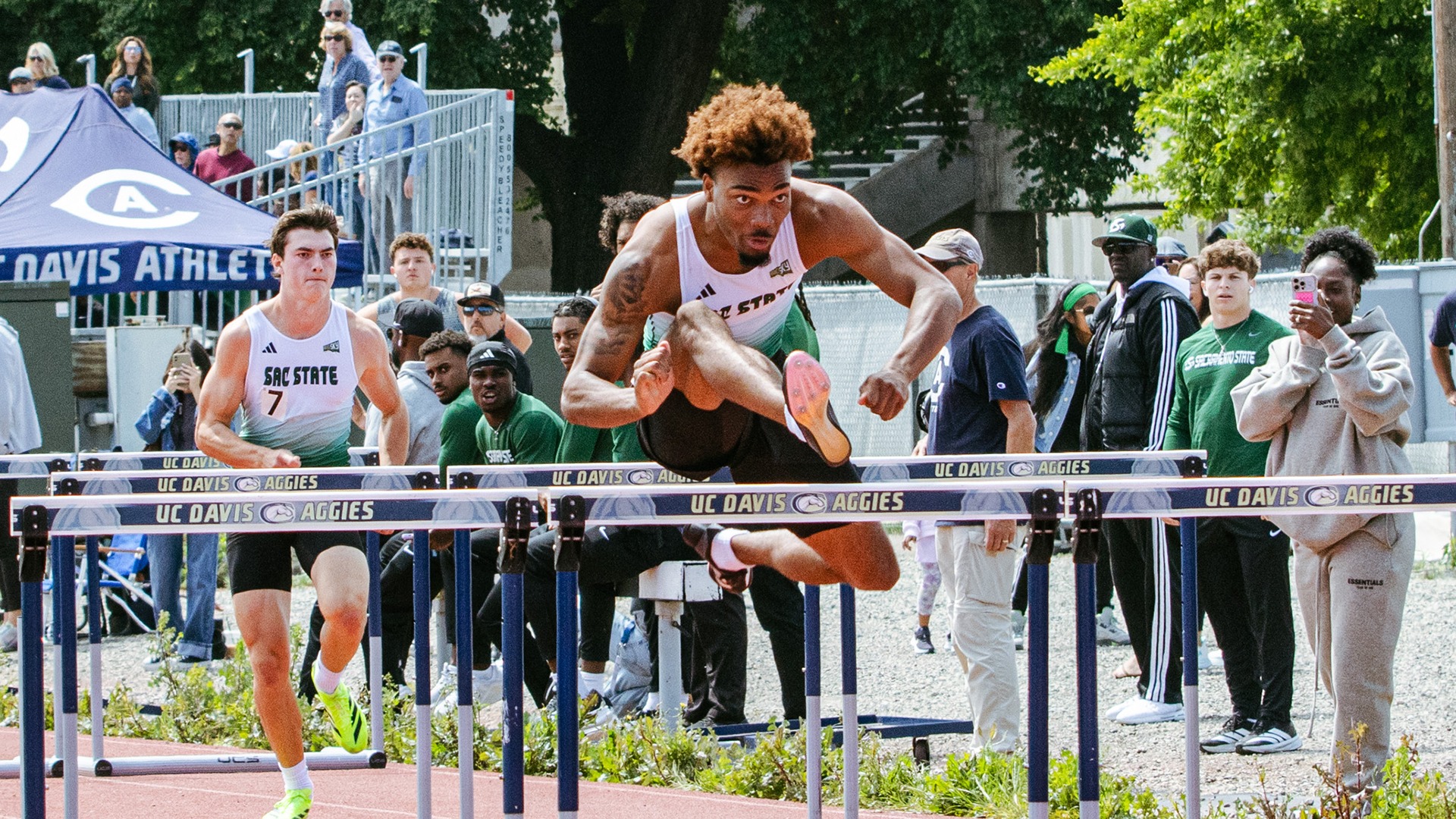 Myles McFarland jumps over the final hurdle in the 110-hurdles